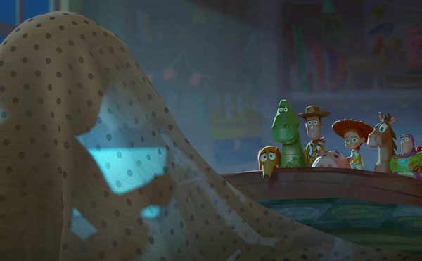 A young girl is sat underneath her blanket, and you can see the light from a tablet. Some toys peer over the edge of her bed, looking at her worryingly.