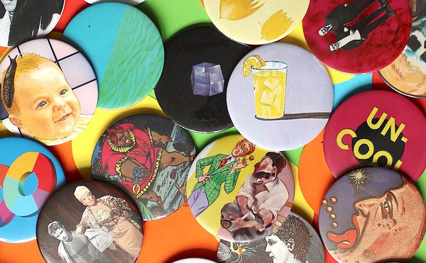 A pile of bold bright coloured badges sat on a table.